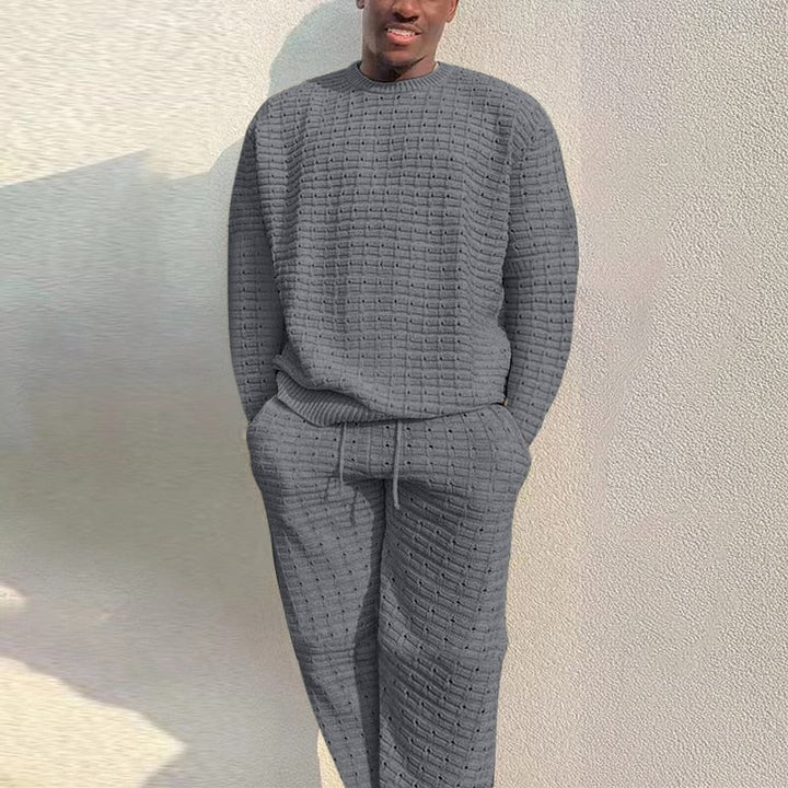 Man wearing grey textured knit crew neck jumper and matching lounge pants | Grace Aura