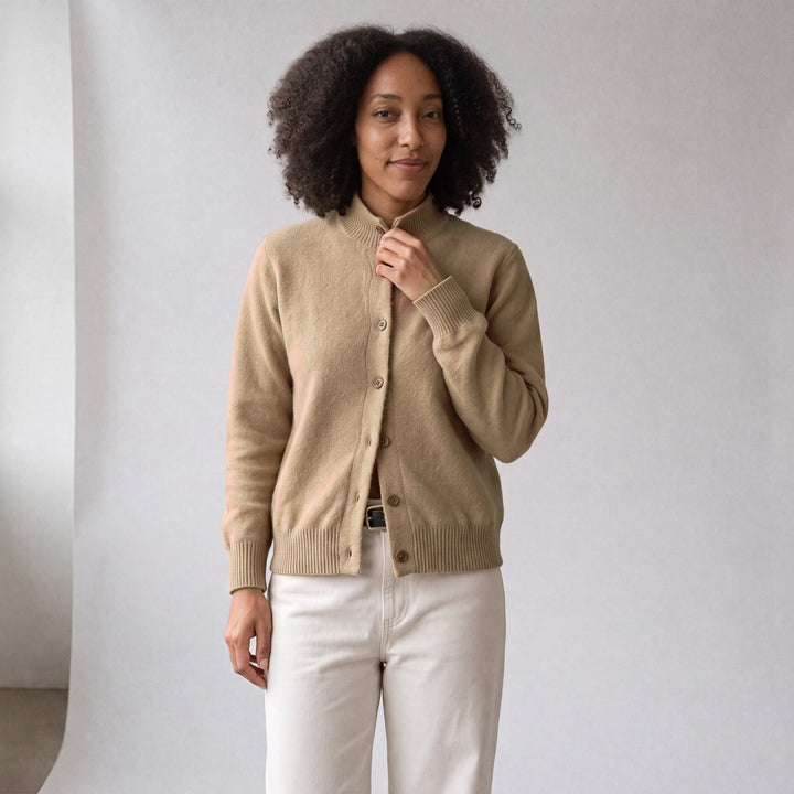 Woman in a beige knit cardigan with stand collar