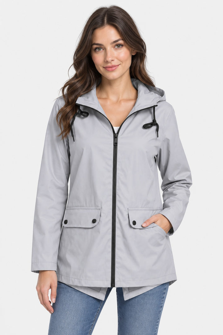 Light grey lightweight rain jacket with hood, full zip and flap pockets, worn over jeans