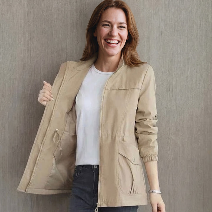 Woman wearing the Khaki lightweight rain jacket with stand collar
