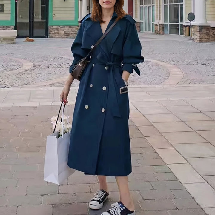 Navy long belted trench coat worn outdoors