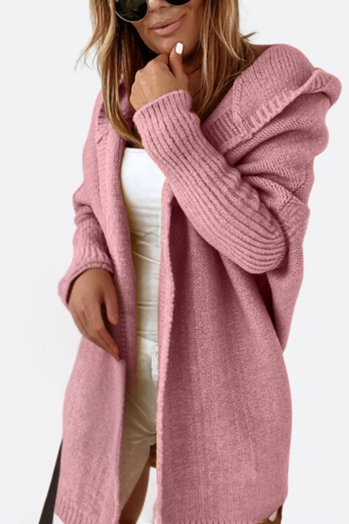 Pink long hooded cardigan worn open over a white top