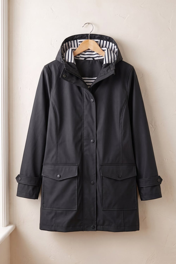 Black hooded rain jacket on a hanger, front view