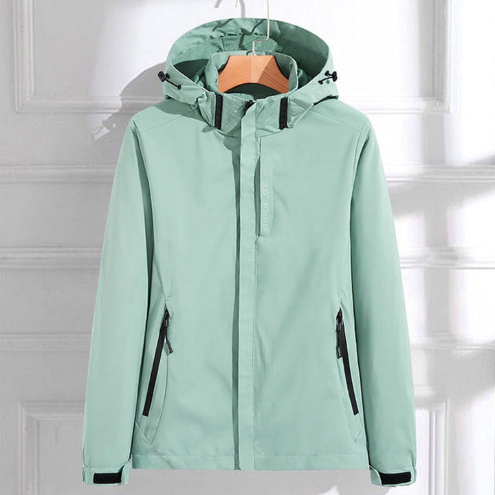 Mint hooded waterproof windbreaker with black-trimmed zip pockets, on a hanger