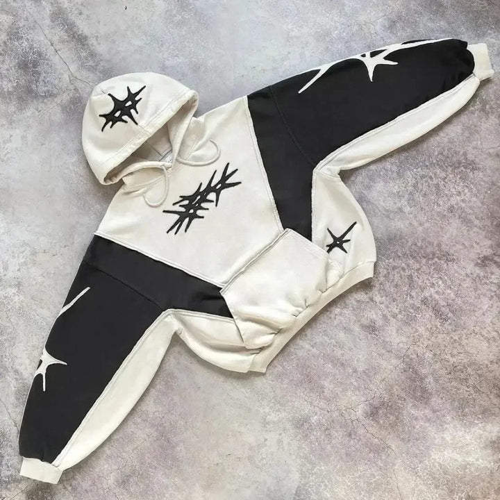 Black and white two-tone hoodie with star patchwork