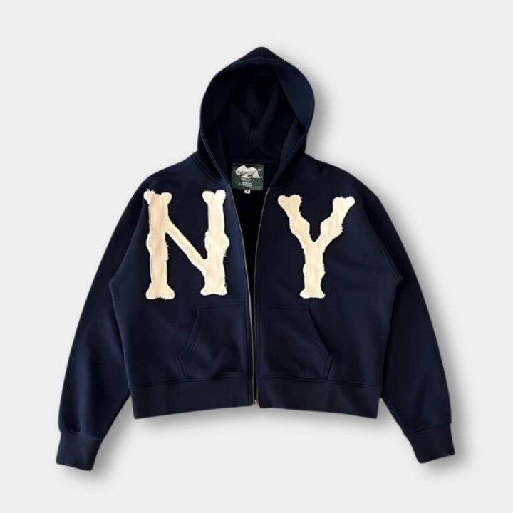 Navy oversized zip-up hoodie with a cream NY applique, front view
